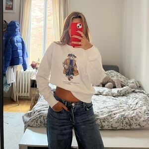 Nice white polo sweater with a teddy bear